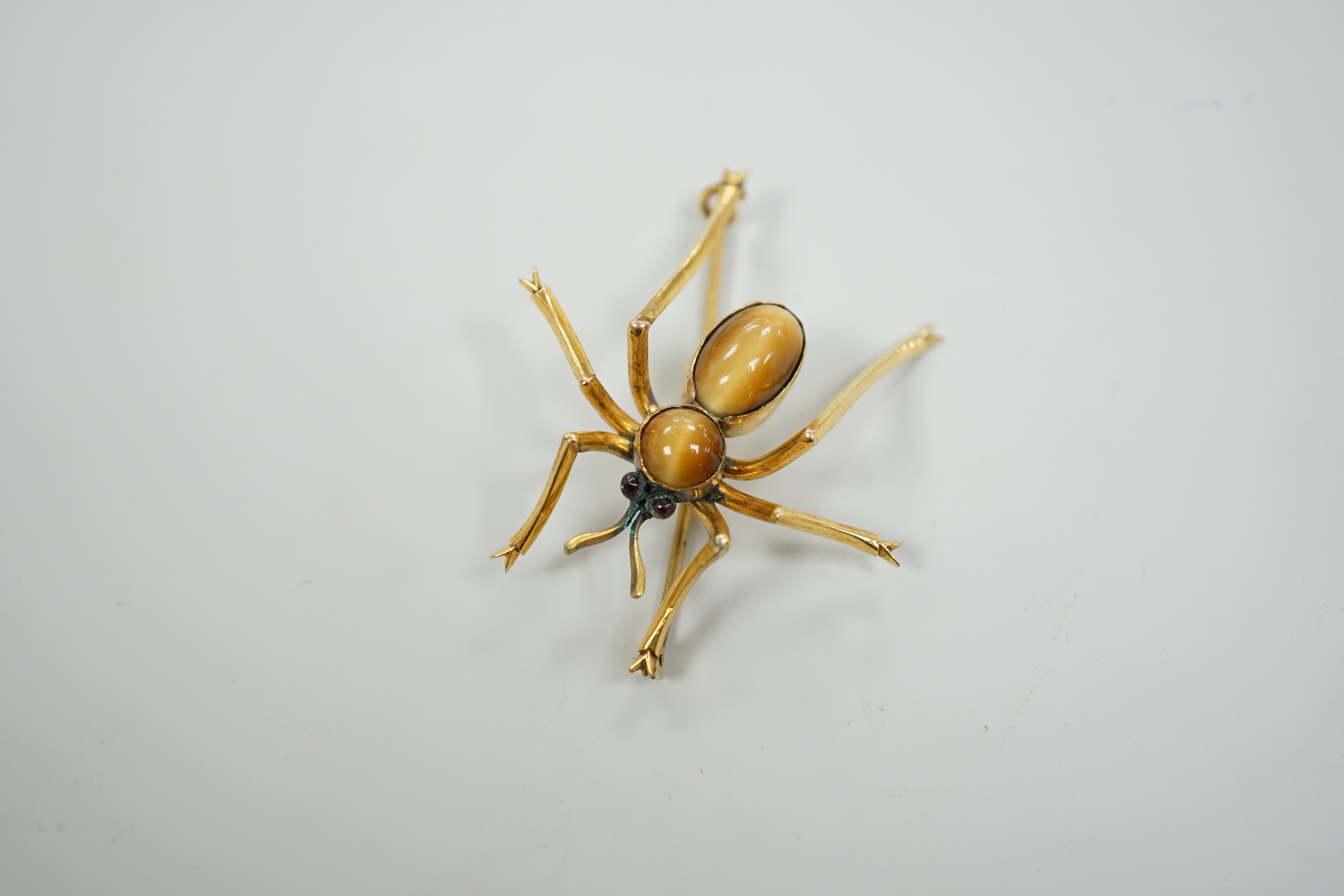 A yellow metal, tiger's eye quartz and gem set spider brooch, 41mm, gross weight 6.1 grams.